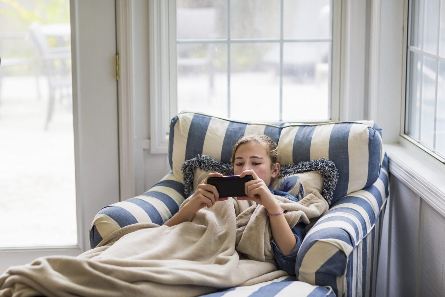 13 year old girl looking at smart phone